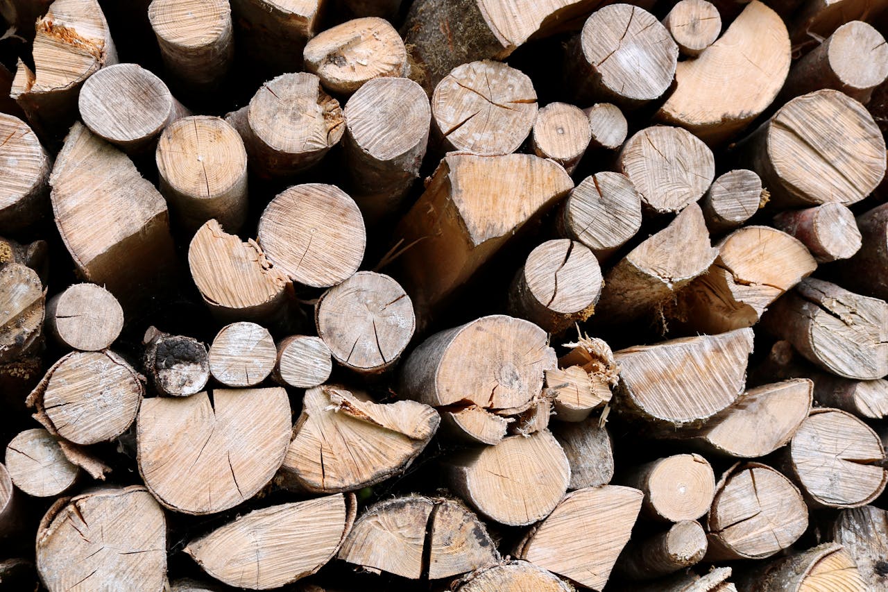 Close-up view of stacked firewood logs in Hallstatt, Austria, showcasing natural patterns and textures.