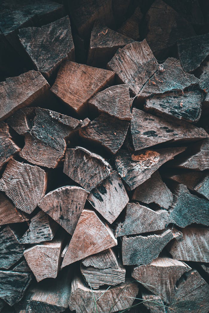 A close-up view of stacked chopped firewood, ideal for rustic decor or woodwork themes.